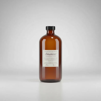 Frasco ámbar de 500 ml con etiqueta "Aroma para Difusores · Amanecer · Río de Magma" sobre fondo blanco, vista frontal
