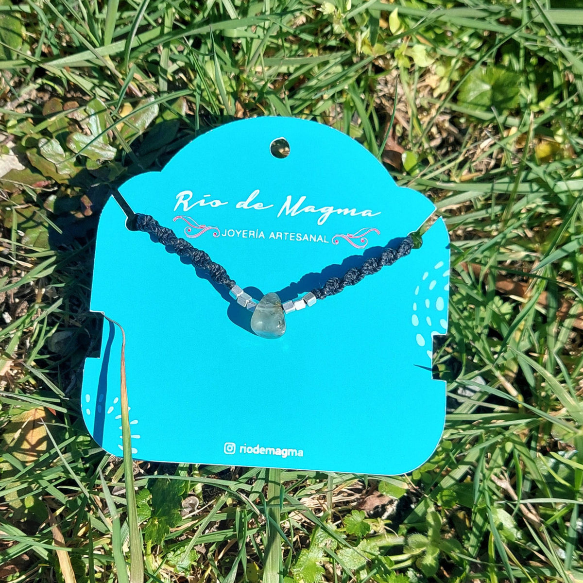 Collar Luz de prehnita natural con tejido de macramé negro y cuentas de plata 950, sobre tarjeta de Río de Magma Joyería Artesanal
